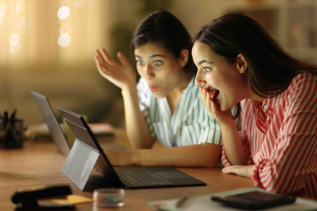 Amazed tele workers checking laptop in the night at home