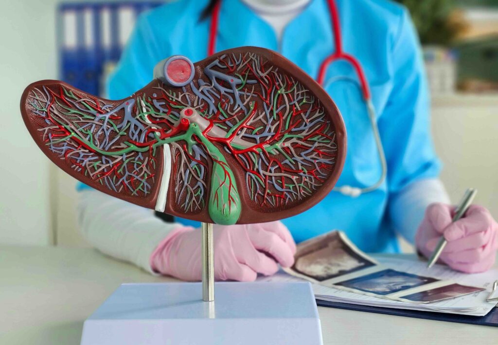 Nurse works at a desk. Woman, including liver disease, hepatitis, cirrhosis, and liver cancer.