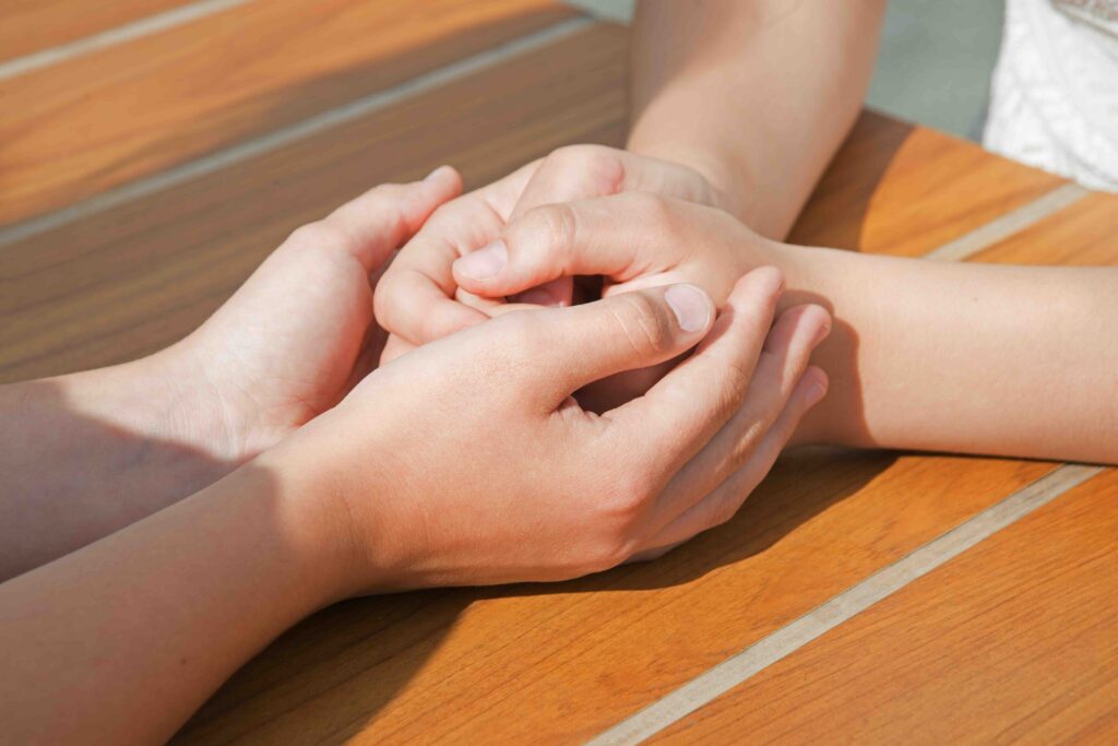 2 young teen joy happy cheer lady sister sit cuddl hug daughter finger cry talk cafe table. Bad boy guy student relation youth feel offend mourn grief pain mood emot tell advice trust god faith crisis